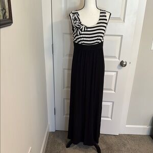 Kim Rodgers| Black and white striped maxi dress with a stylish ruffle detail.